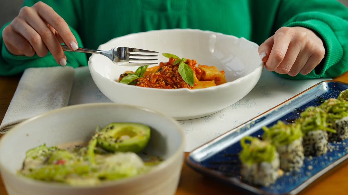A delicious fusion meal featuring Italian pasta and sushi, showcasing diverse culinary delights.